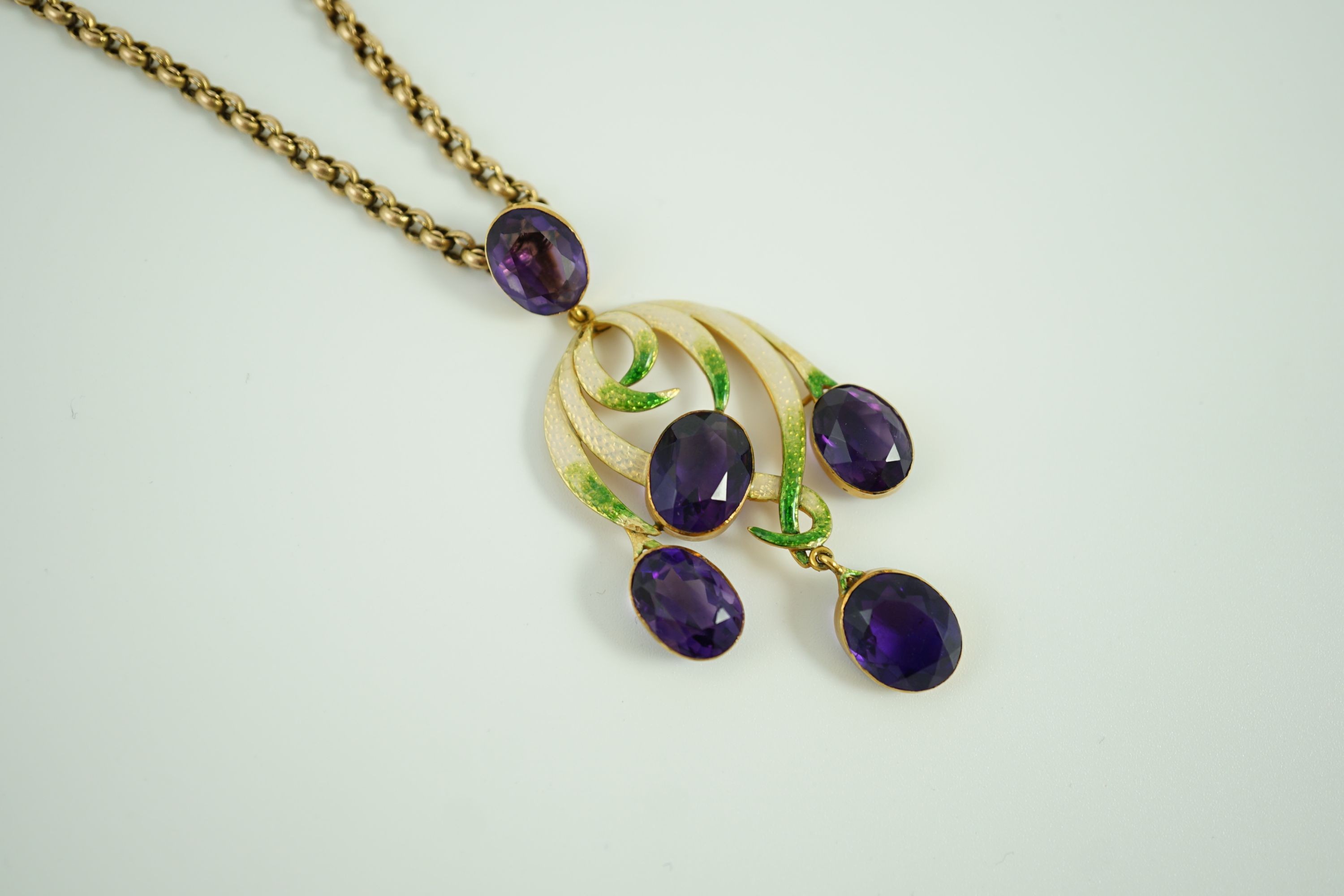 An early 20th century continental gold, enamel and five stone oval cut amethyst set drop pendant, of scrolling design